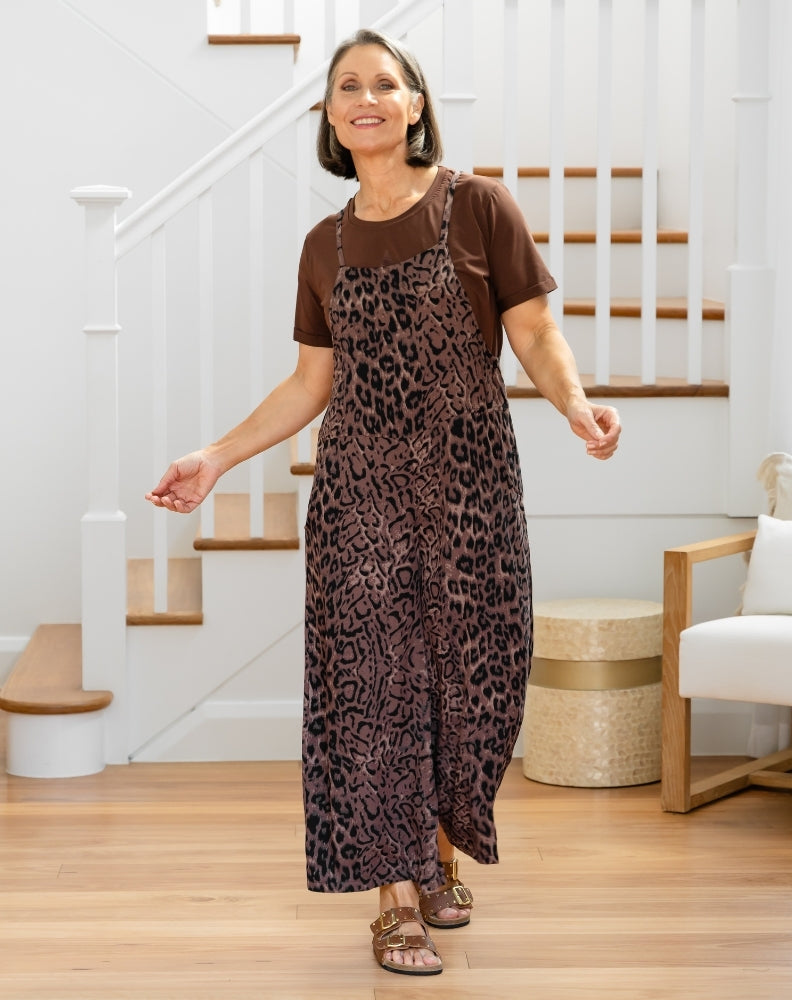 Woman wearing a brown leopard print dress in a home setting