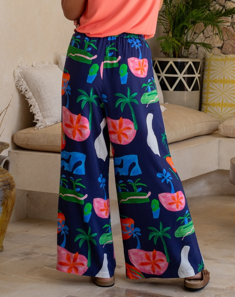 Person wearing colorful patterned pants in a living room setting