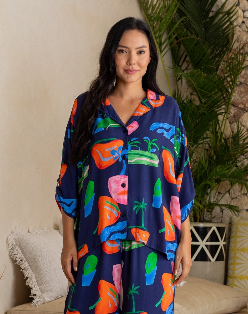 Woman wearing a colorful patterned dress in a home setting