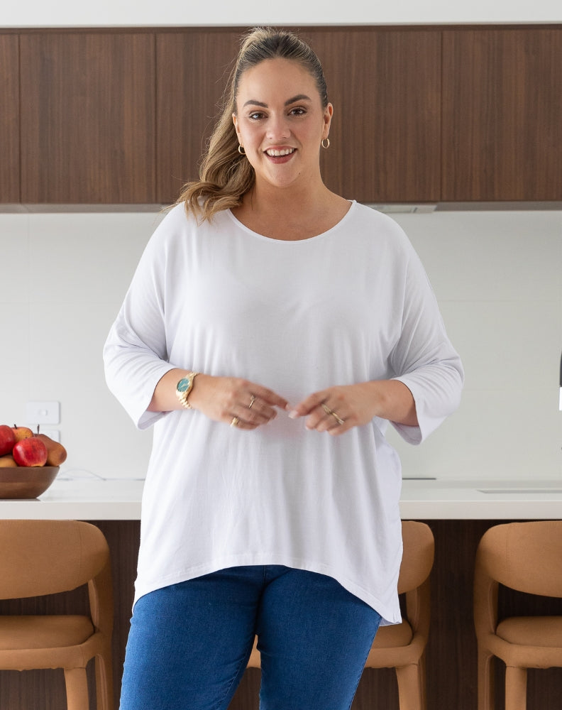 Woman in a white shirt standing in a kitchen