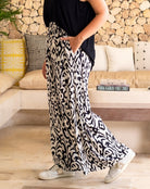 Person wearing a black and white patterned skirt in a living room setting.