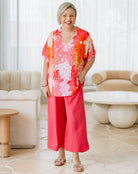 Woman wearing a colorful outfit in a modern living room.